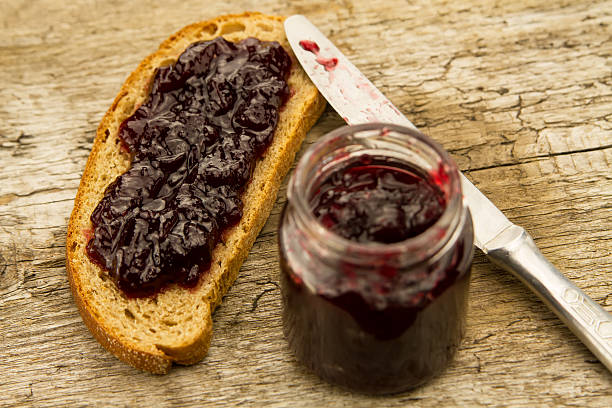 istock piece bread with jam and knife on wooden background 477013950