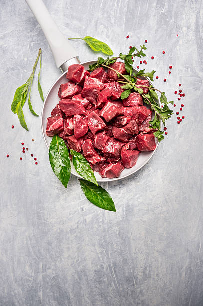 Beef stew prepared  for goulash cooking in white pan