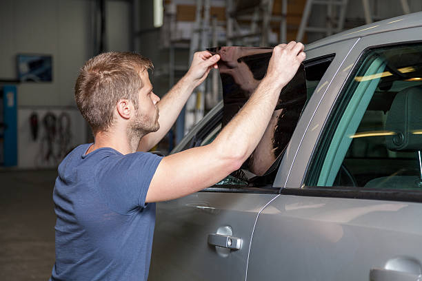 istock Applying tinting foil onto a car window 477014614