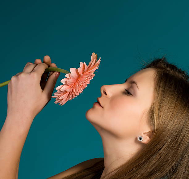 istock Attractive woman smelling big flower 477015629
