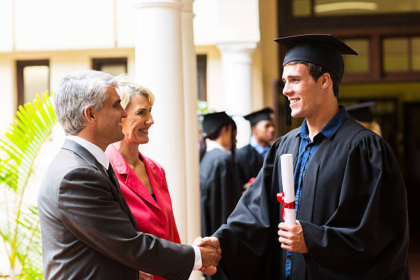 istock proud father congratulating his son on graduation 477016107