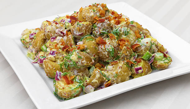 Potato Salad Potato salad served on a square plate. chopped dill stock pictures, royalty-free photos & images