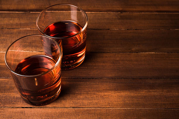 istock Cognac glass on wooden table 477017146