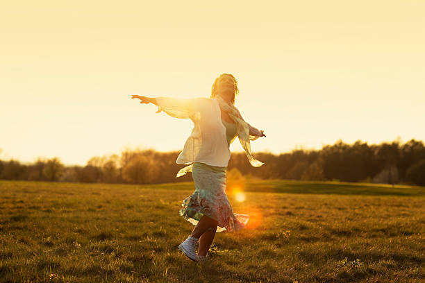istock young woman on meadow sunset 477020820