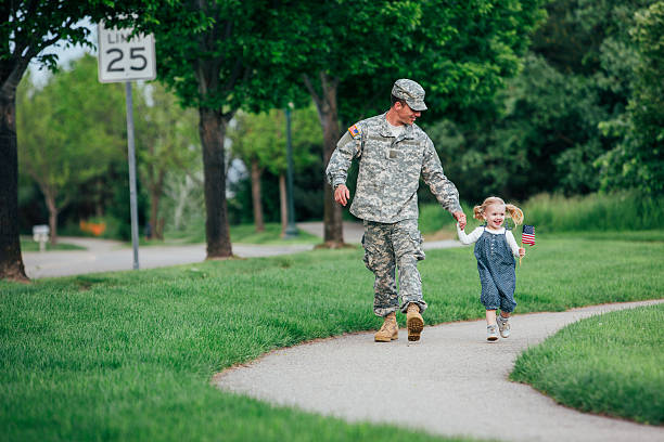 istock American soldier walking with his daughter 477021840