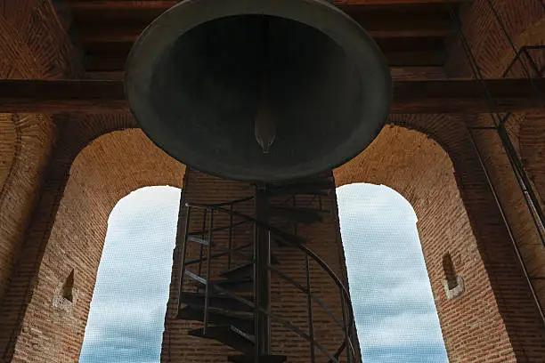 Beneath a big iron bell inside a church in Medina del Campo, Valladolid, Spain.