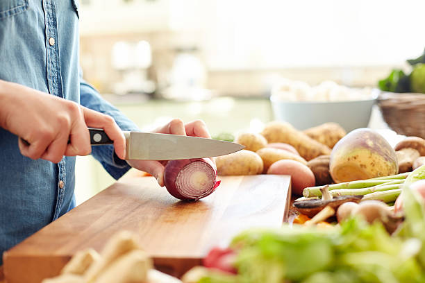 istock Midsection image of woman cutting onion in kitchen 477022312