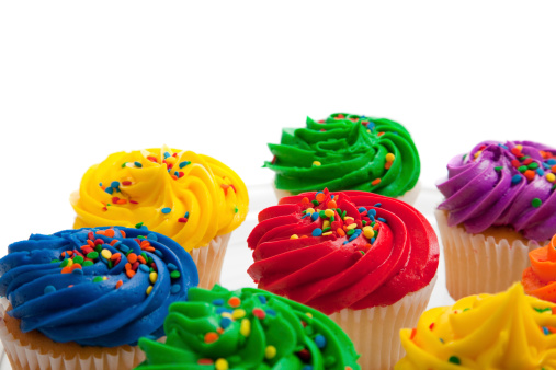 Multi colored cupcakes on white background