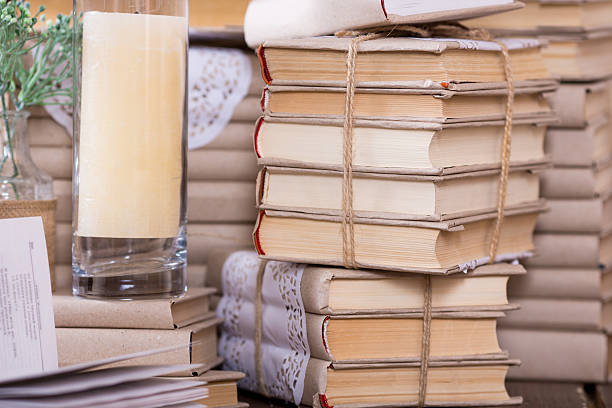istock Old books heap and candle 477028532