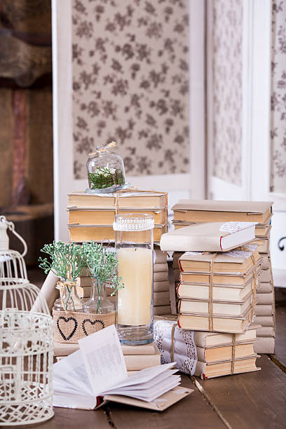 istock Old books heap and candle in interior decoration 477028614