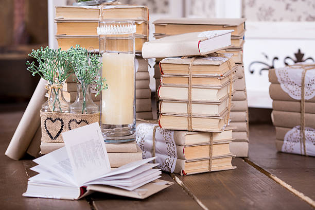 istock Old books heap and candle in interior decoration 477028618