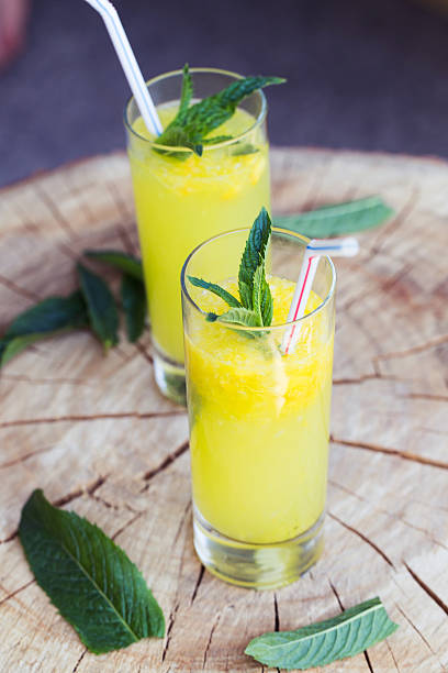 istock Orange drink on wooden table, selective focus 477028776