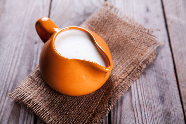 istock healthy drink. orange clay jug with milk in rustic style 477029056