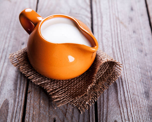 istock healthy drink. orange clay jug with milk in rustic style 477029078