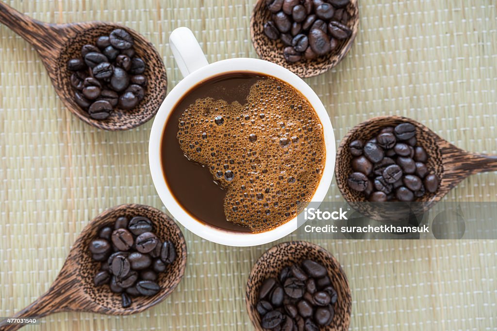 cup of coffee and coffee beans cup of coffee and coffee beans on wooden spoon 2015 Stock Photo