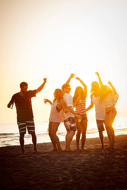 istock Friends dancing at the beach 477031794