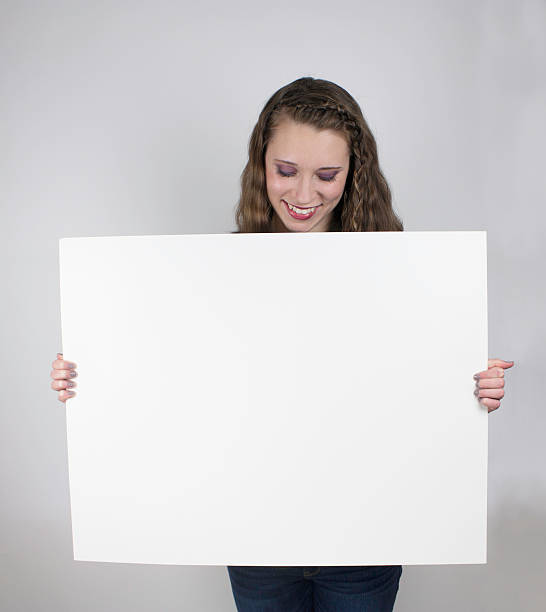 istock Pretty young woman holding blank sign 477036501