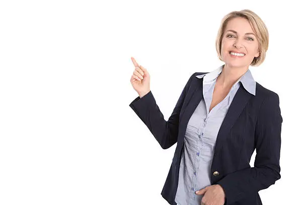 Pretty blond mature business woman pointing with forefinger isolated on white.