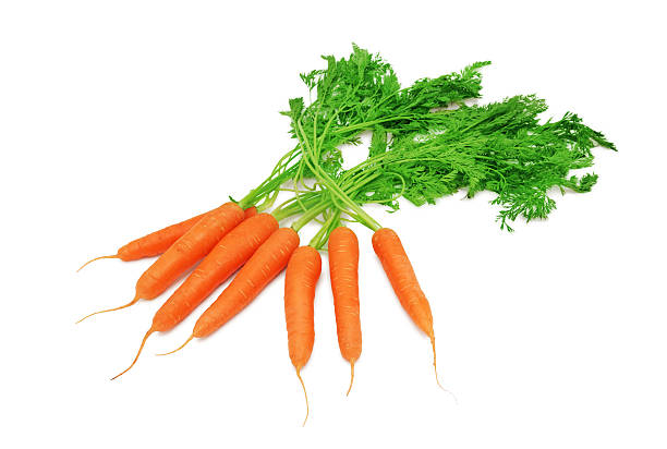 istock Stack of ripe carrots with green tops (isolated) 477041548