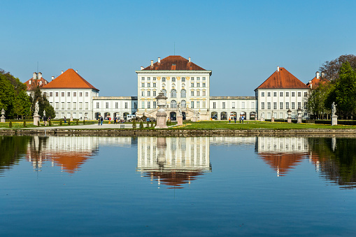 Munich, Germany - April 20, 2015: people at Nymphenburg Palace, the summer residence of the Bavarian kings, in Munich, Germany. This palace welcomes 300,000 visitors per year.