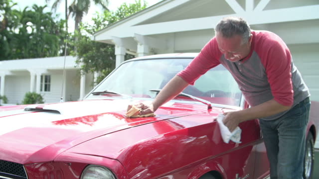 Retired Senior Man Cleaning Restored Classic Car