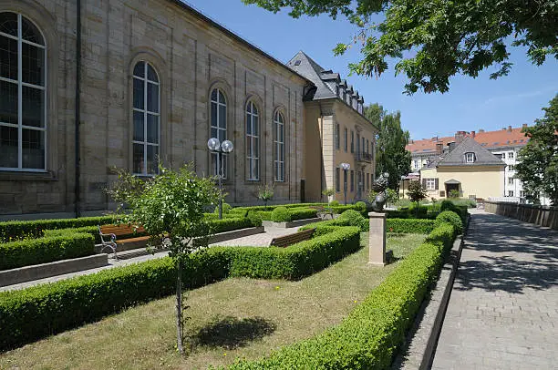 Ornamental garden in Bayreuth, Franconia, Bavaria, Germany, between opera house to the right and Schlosskirche (means church of the castle) to the left