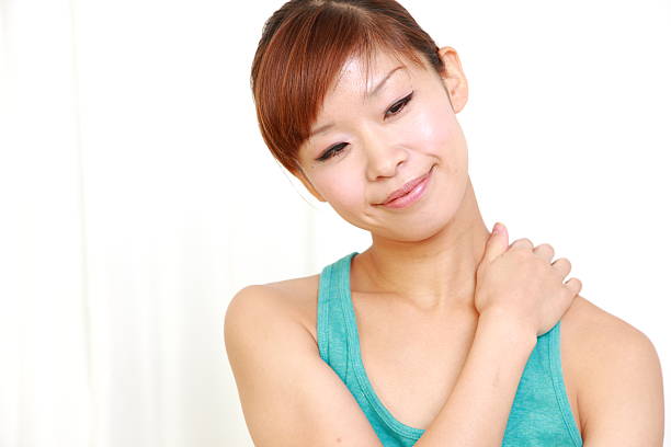 istock young japanese woman doing self shoulder massage 477044255