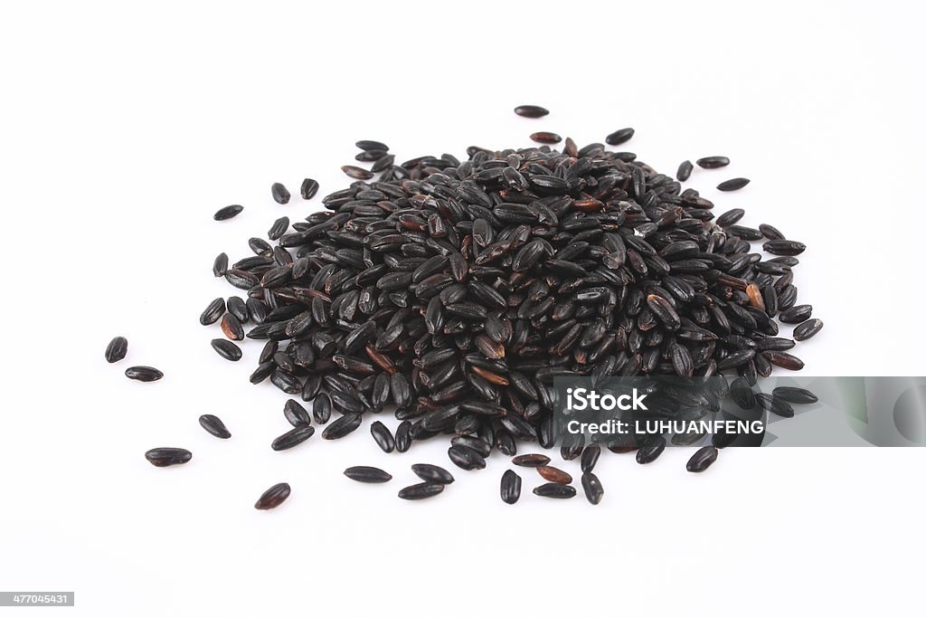 Black rice on a white background Black Rice Stock Photo