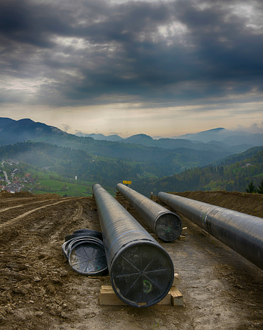 Dark clouds over pipeline construction in hilly landscape, Slovenia, Europe.