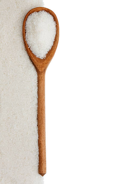 istock wooden spoon with sugar 477052337