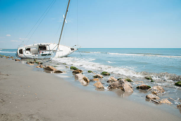 istock sailboat wrecked and stranded on the beach 477053684