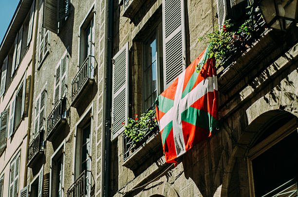 Hanging basque flag A basque flag hanging down a window comunidad autonoma del pais vasco stock pictures, royalty-free photos & images