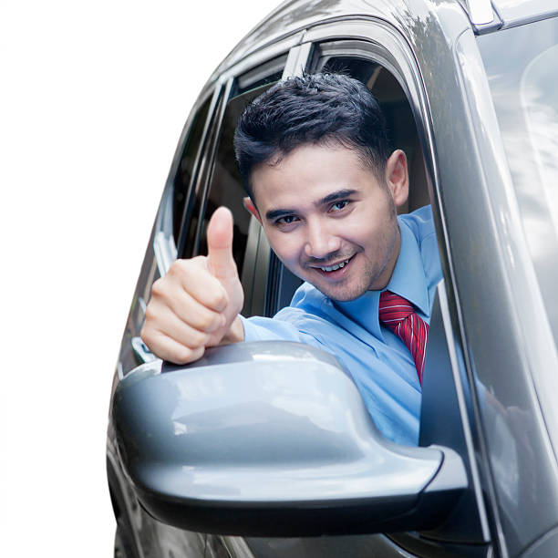 istock Successful man showing thumb up in car 477059044