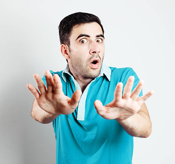 istock Male with blue shirt being scared in front of camera 477059707