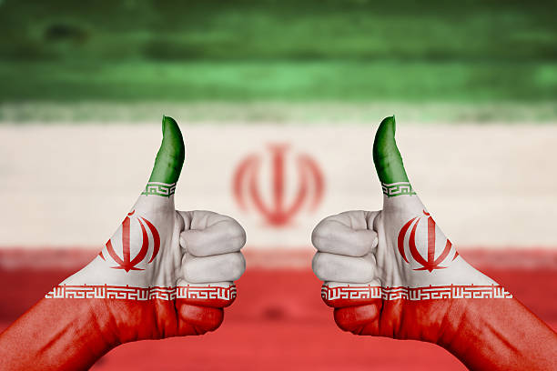 istock Iran flag painted on female hands thumbs up 477061878