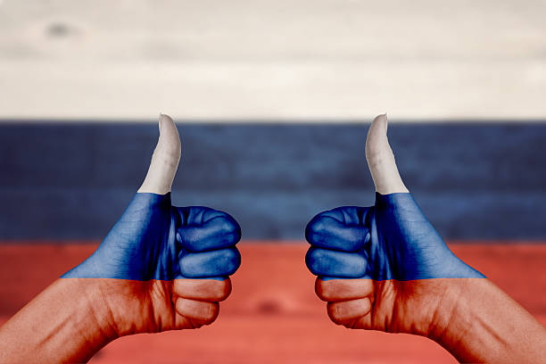 istock Russia flag painted on female hands thumbs up 477061994