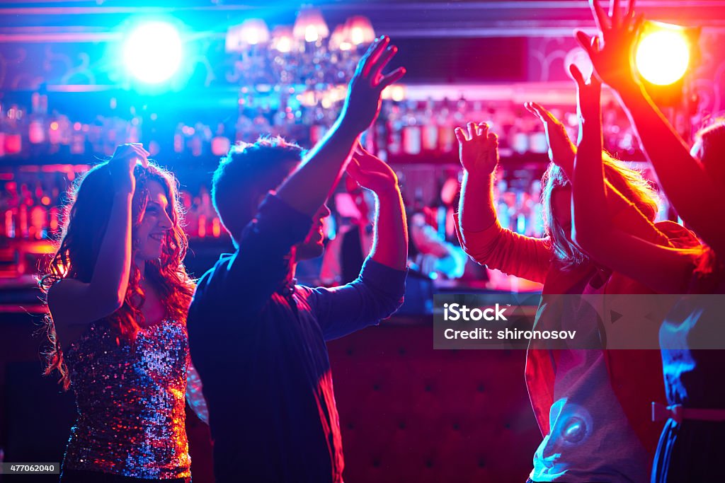 Dancing Energetic friends dancing in night club Nightlife Stock Photo