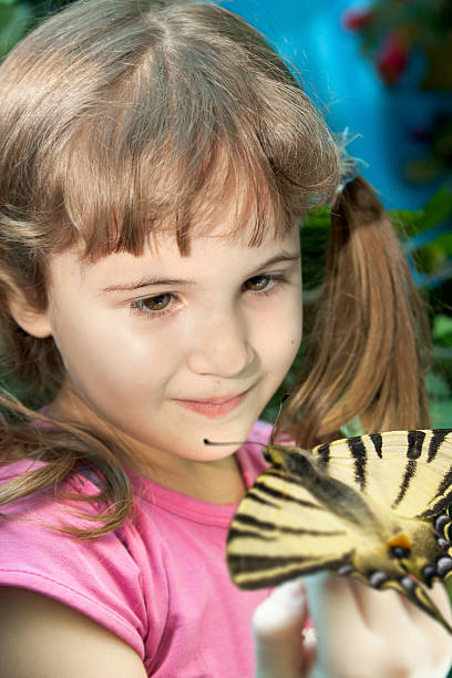 istock Girl with a Big Bright Butterfly 477062054