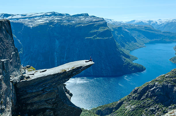 istock Trolltunga summer view (Norway) and man on rocks edge. 477068541