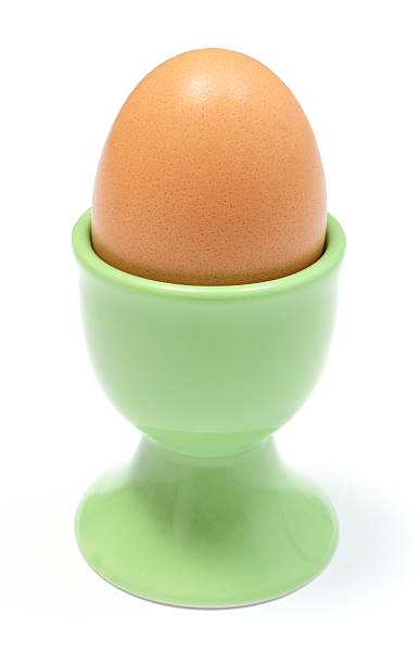 istock Closeup of boiled egg in green cup. White background 477069823