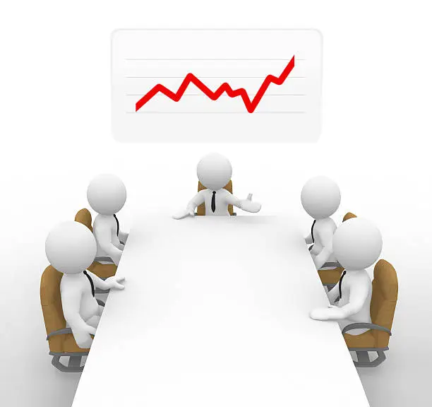Businessmen hold a meeting. A stock graph can be seen in the background.