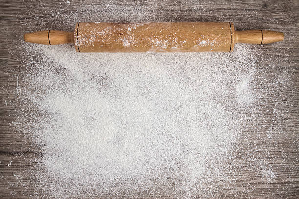 Rolling Pin on Woooden Floured Background