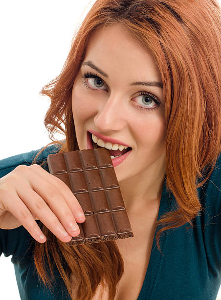 istock Happy woman eating a yummy chocolate. 477077942