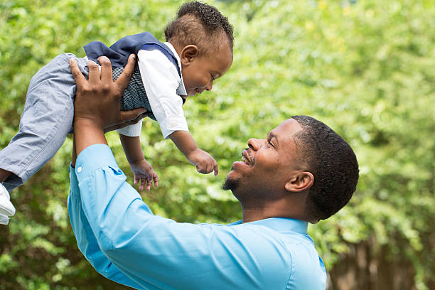 istock African American father and son playing 477083094
