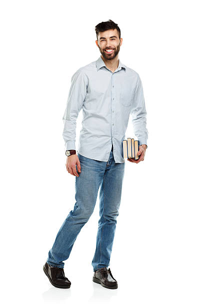 istock Young bearded smiling man with books in hands on white 477083108