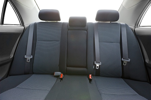 Car interior with back seats, sunlight flaring through