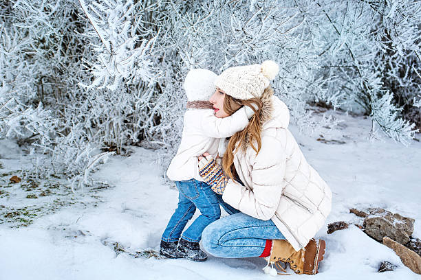 istock Mother and daughter in winter forest 477088185