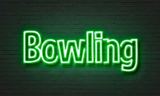 Bowling neon sign on brick wall background