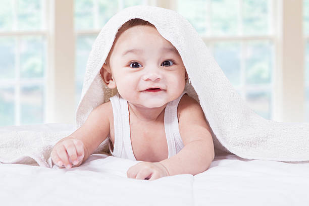istock Male toddler with a cute face on bed 477088612