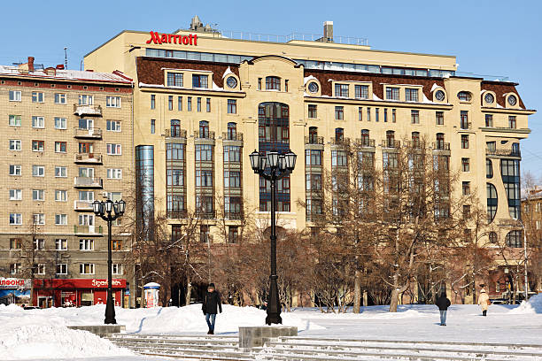 Novosibirsk, Russia - January 23, 2015: People near the hotel Marriott in a winter day. Marriott has more than 3,700 locations in 75 countries and territories worldwide